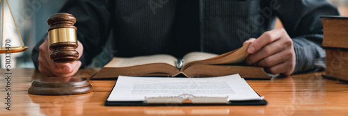 Lawyer or judge holding Hammer prepares to judge the case with justice, and litigation, scales of justice, law hammer,  Legal consulting services, Concept of litigation, and legal services.