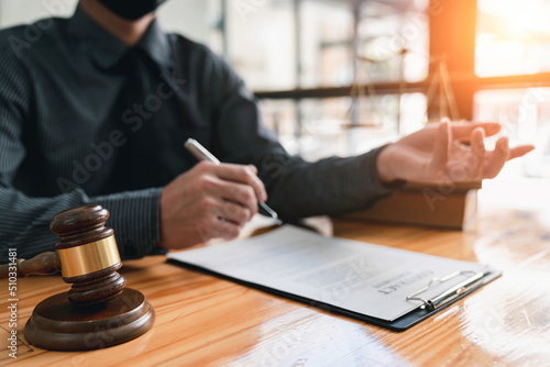 lawyer or judge is giving legal advice. to explaining about consultation terms and conditions to businessmen before signing on contract at a law firm.