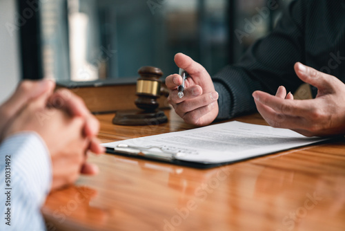 lawyer or judge is giving legal advice. to explaining about consultation terms and conditions to businessmen before signing on contract at a law firm.