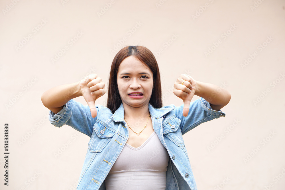 Asian woman raising hand to dislike Asian woman raising hand to dislike