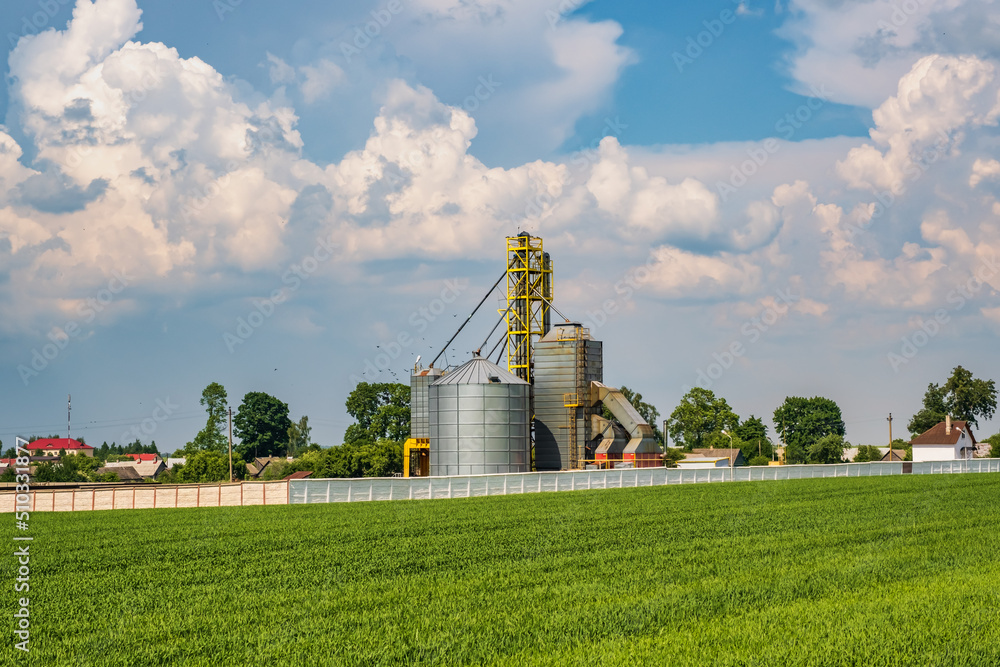 Modern Granary elevator. Silver silos on agro-processing and manufacturing plant for processing drying cleaning and storage of agricultural products, flour, cereals and grain. Modern Granary elevator. Silver silos on agro-processing and manufacturing plant for processing drying cleaning and storage of agricultural products, flour, cereals and grain.
