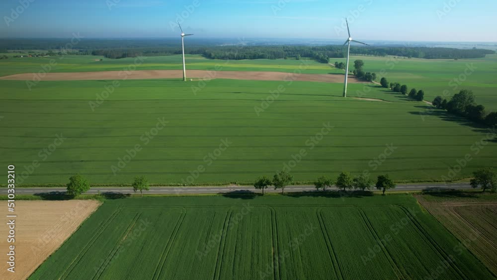 Windmills over fields, aerial drone pull out. Beautiful. Windmills over fields, aerial drone pull out. Beautiful.
