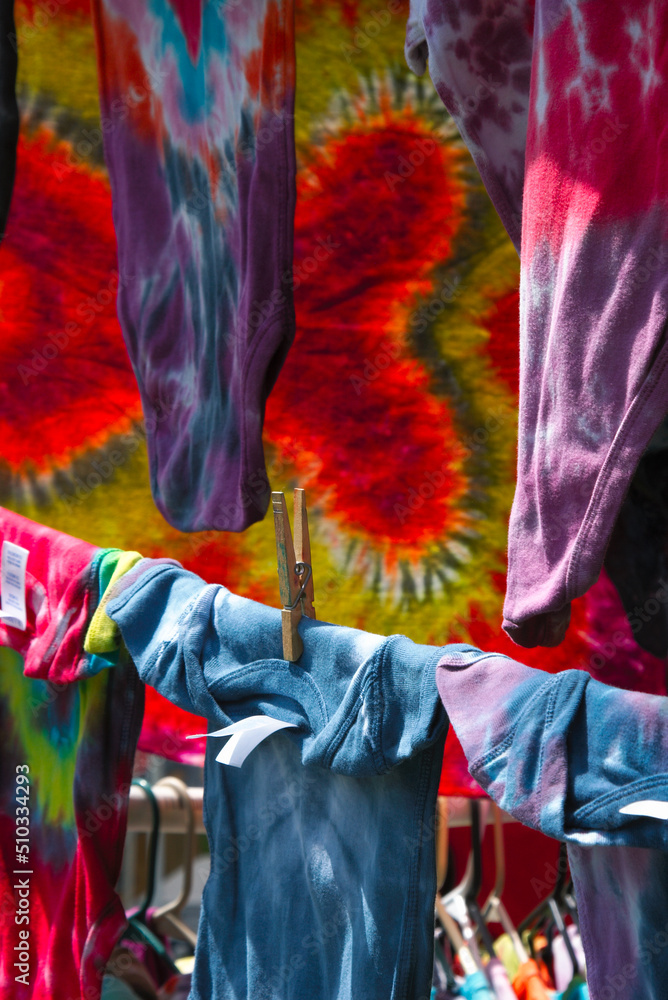 Tie dyed clothing items on display on a clothes line at a an arts and crafts fair. Tie dyed clothing items on display on a clothes line at a an arts and crafts fair.