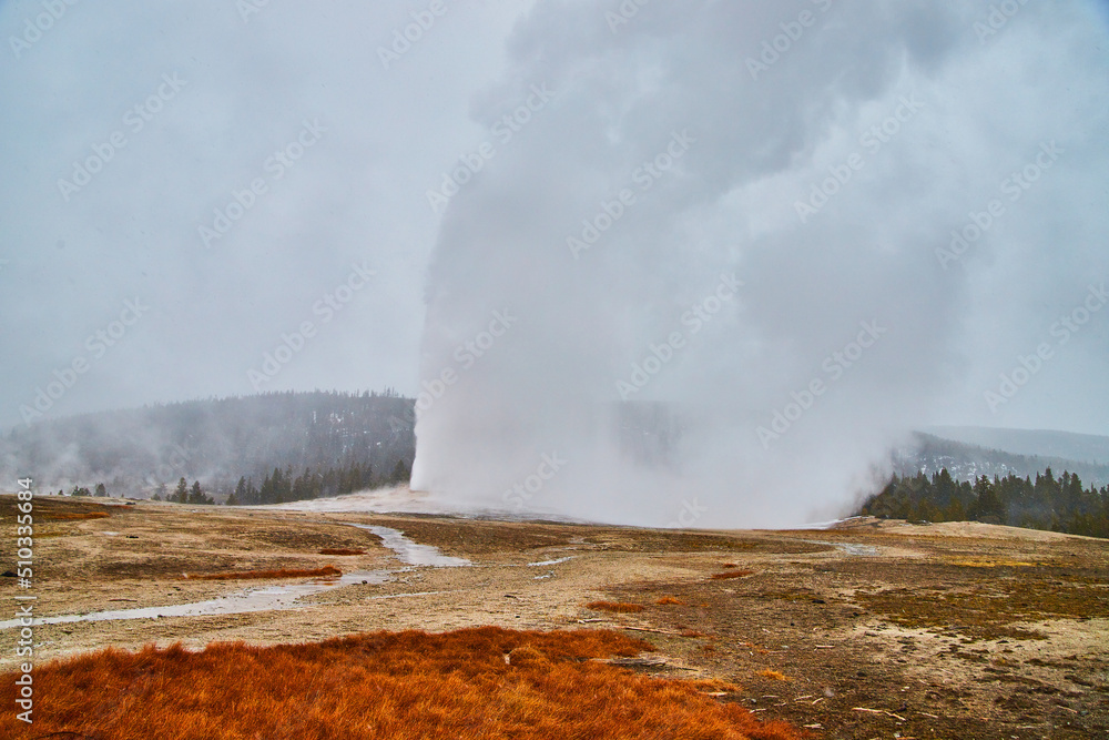 Old Faithful going off on schedule in Yellowstone winter