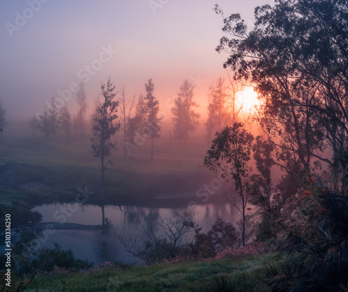 Sunrise Through Mist Over River