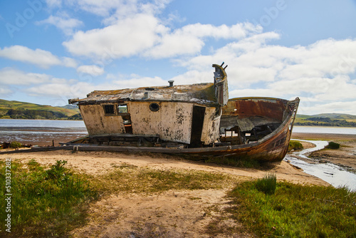 Side profile of shipwreck resting on sandy beach