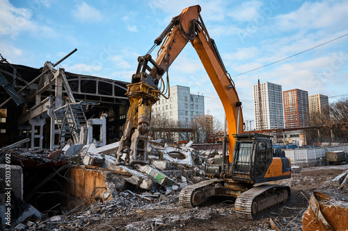 Canvas Print Excavator with hydraulic scissors cuts reinforced concrete