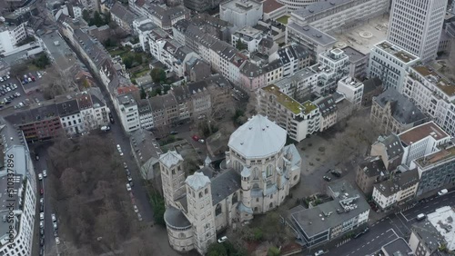 High angle view of St Gereon catholic church surrounded by multistorey apartment houses in urban neighbourhood. Cologne, Germany photo