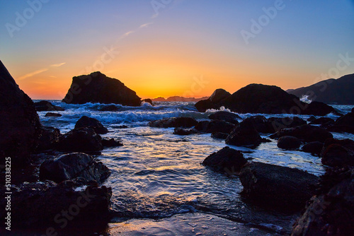 Rocky beach at golden hour on ocean in California