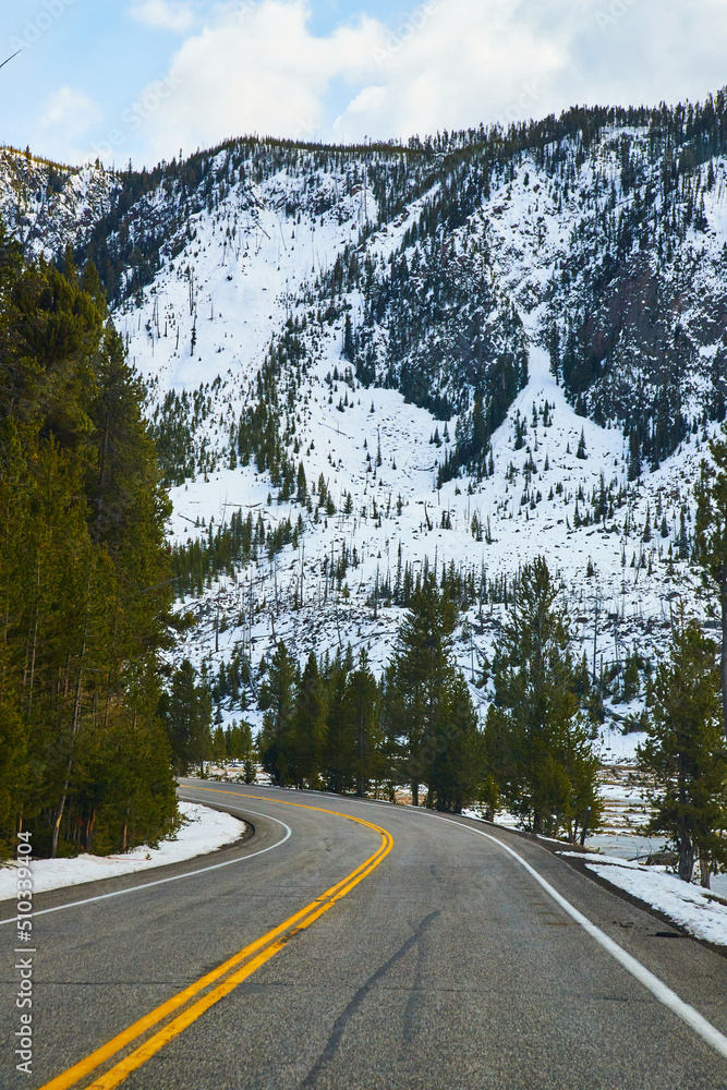Road leading through snowy mountains in Yellowstone