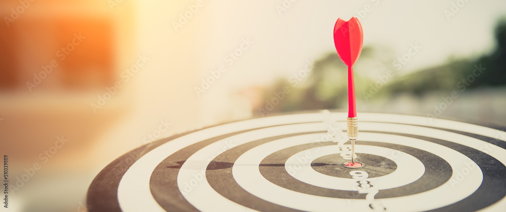 Bullseye or Bulls eye target or dartboard has dart arrow throw hitting the center of a shooting for financial business targeting planning and aim to winner goal of business concept. Bullseye or Bulls eye target or dartboard has dart arrow throw hitting the center of a shooting for financial business targeting planning and aim to winner goal of business concept.