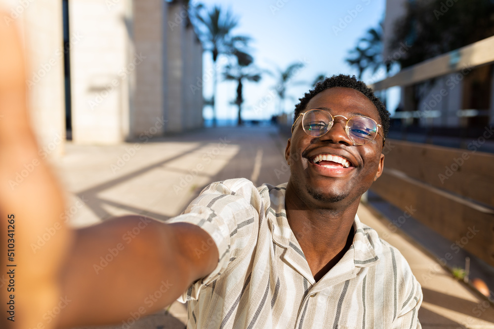Happy young black man with glasses taking selfie looking at camera. Happy young black man with glasses taking selfie looking at camera.