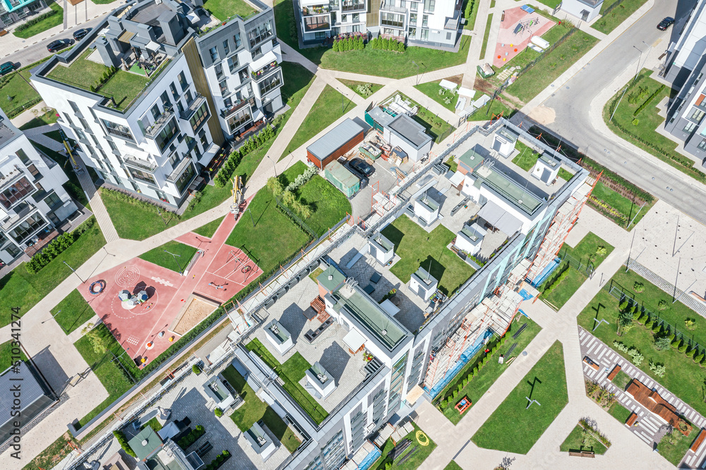 modern residential buildings complex with green grass floor on roofs. aerial view in sunny summer day. modern residential buildings complex with green grass floor on roofs. aerial view in sunny summer day.