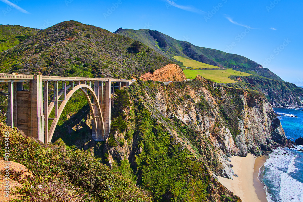 Stunning arched Bixby Bridge on west coast with beaches, mountains, and ocean