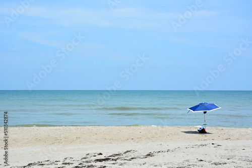 Fototapeta Naklejka Na Ścianę i Meble -  Empty beach with a single umbrella or parasol in Cocoa Beach, Florida