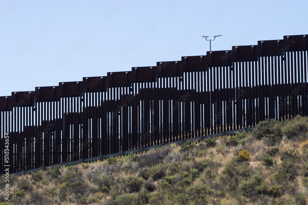 A double vertical border wall between the United States and Mexico ...