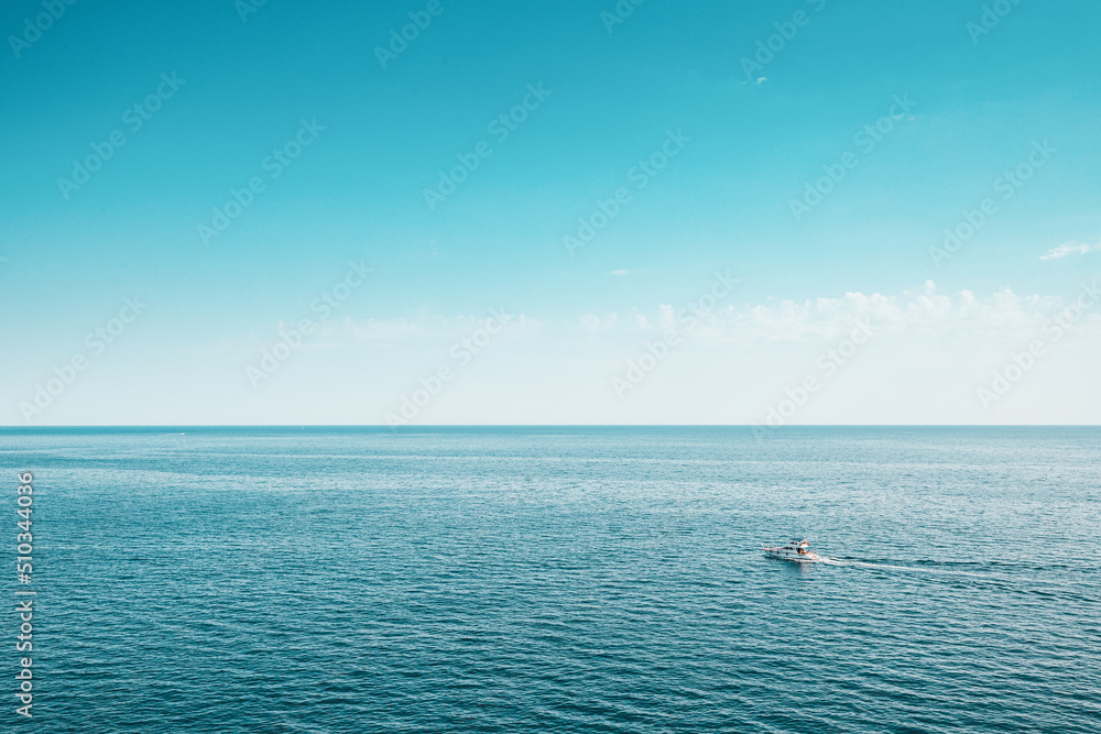 Alone ship or yacht is sailing in open sea. Minimalism and vacation background