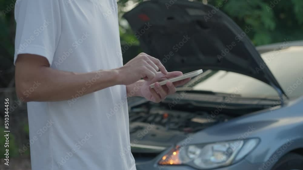 Man use mobile phone inform for help due to emergency car through a mobile application system. A man searches for a garage to have his car repaired during a rural tour. car insurance concept... Man use mobile phone inform for help due to emergency car through a mobile application system. A man searches for a garage to have his car repaired during a rural tour. car insurance concept...