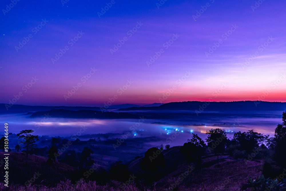 Landscape of the mountains and field with fog before sunrise