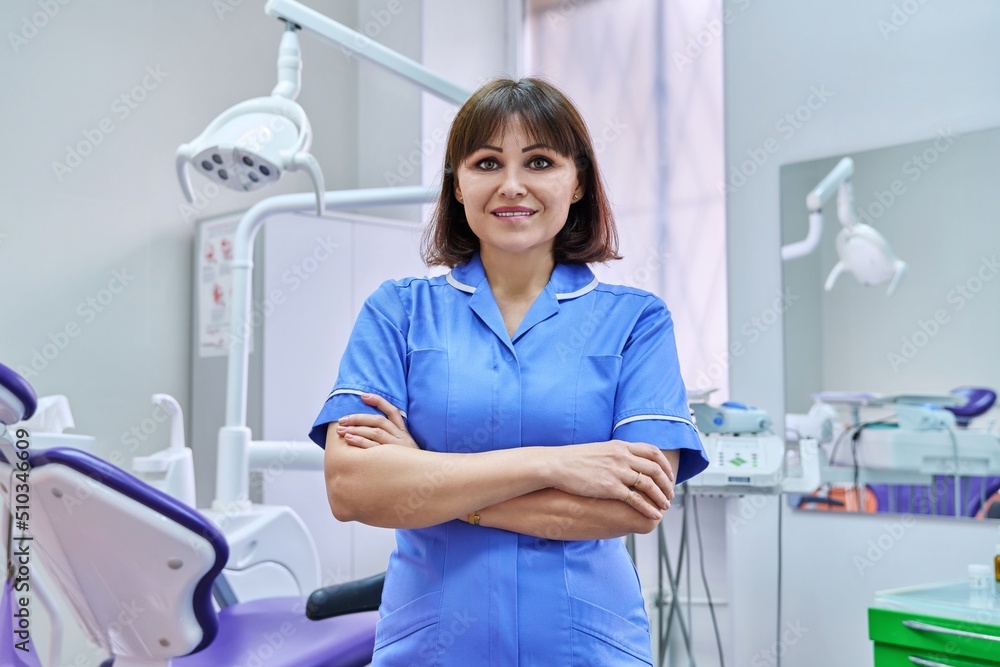 Portrait of smiling nurse looking at camera in dentistry. Portrait of smiling nurse looking at camera in dentistry.