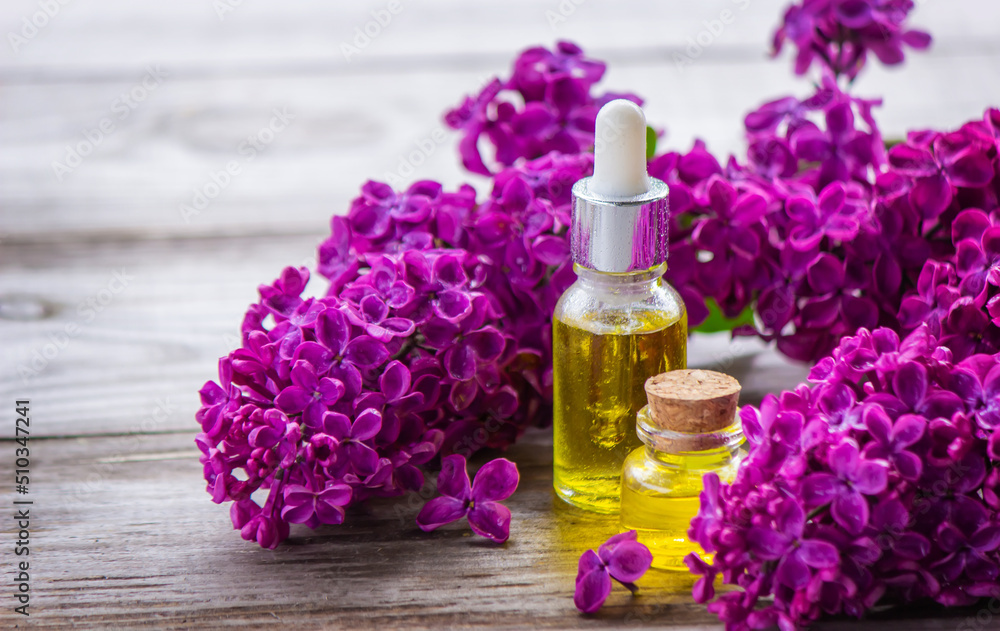 Lilac essential oil in a small bottle. Lilac essential oil in a small bottle.