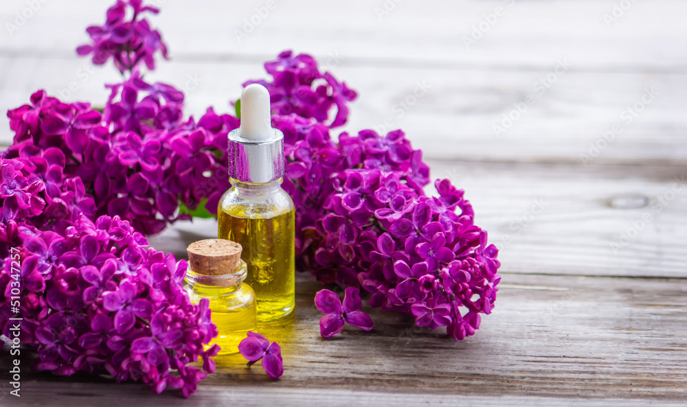 Lilac essential oil in a small bottle. Lilac essential oil in a small bottle.
