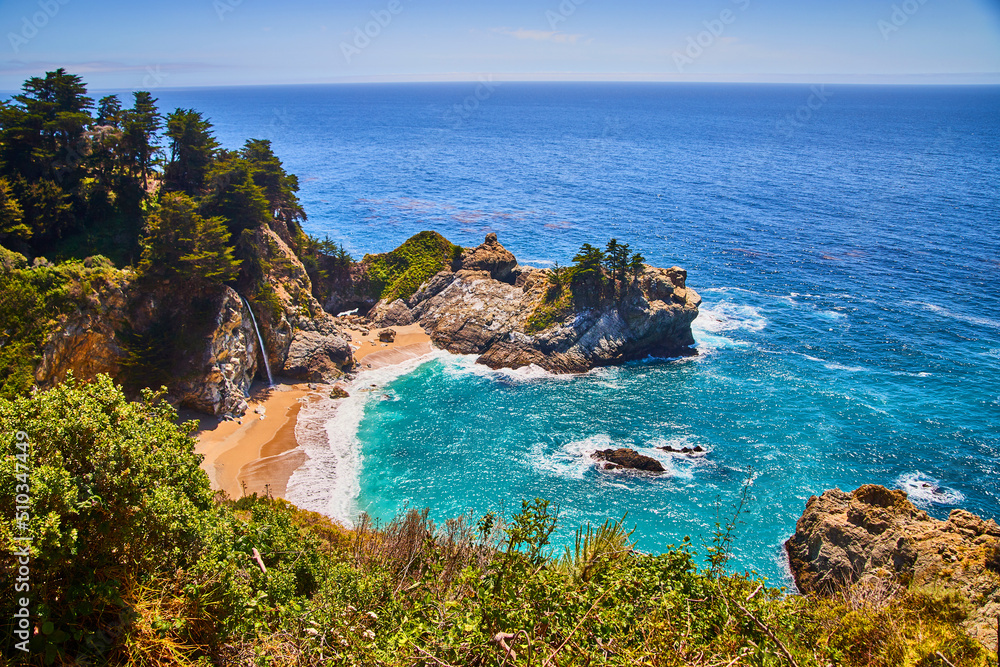 McWay waterfall hidden in coastal beach cove with sandy beaches and