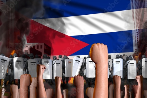 Photography Protest in Cuba - police squad stand against the demonstrators crowd on flag bac