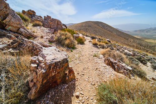 Stunning desert hiking path through top of mountains photo