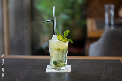 Mojito cocktail served in a glass with straws