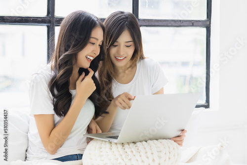Two beautiful asian women using laptop computer talking and smiling while sitting on bed at home Happy girls using laptop for Internet and social media Beautiful young lady enjoy using laptop computer Free Download Two beautiful asian women using laptop computer talking and smiling while sitting on bed at home Happy girls using laptop for Internet and social media Beautiful young lady enjoy using laptop computer - GFXLoad