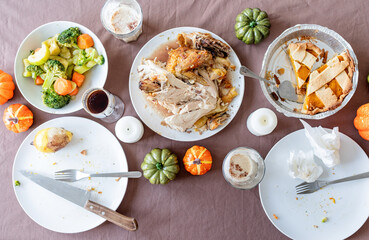 top view of thanksgiving table after feast, leftovers and dirty dishes