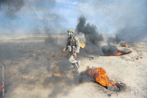 Almaty, Kazakhstan - 08.22.2012 : Soldiers pass a burning obstacle course in gas masks. © Vladimir