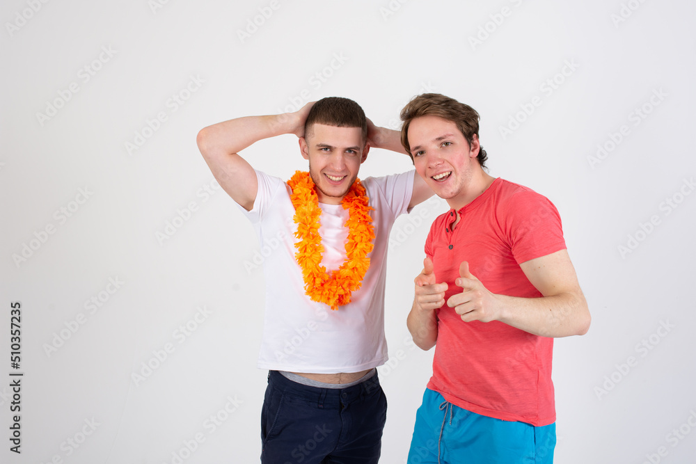 Vacation and holidays. Two attractive guys are going to have a rest on the sea. Cheerful gay couple.	
