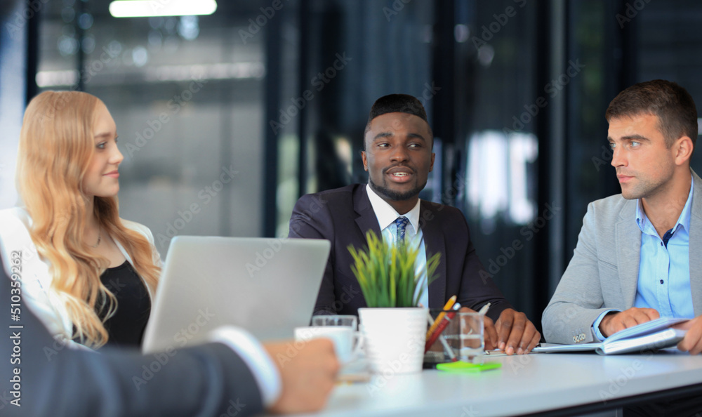 Fototapeta premium Business people in discussing something while sitting together at the table.