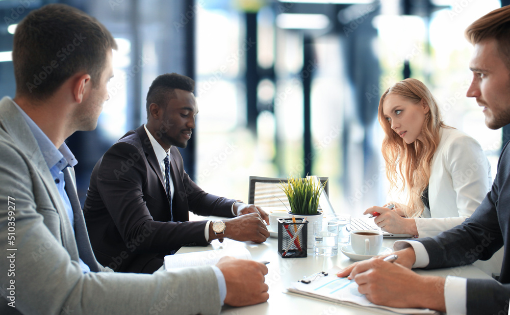 Business people in discussing something while sitting together at the table. Business people in discussing something while sitting together at the table.