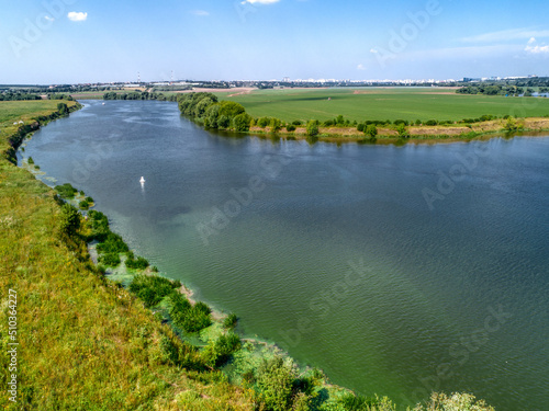 Wide river flowing between fields
