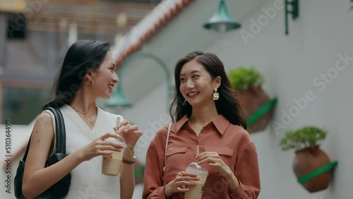 happy shopping girlfriends on the street at night