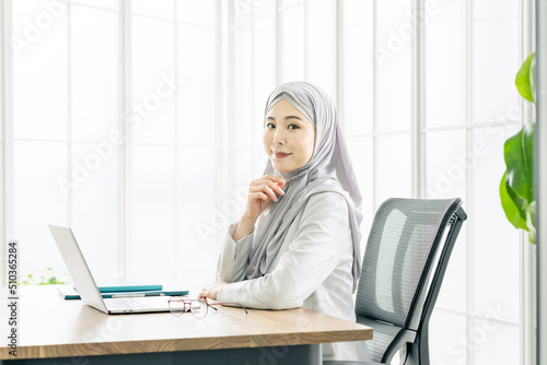 Asian woman with a hijab working in the office