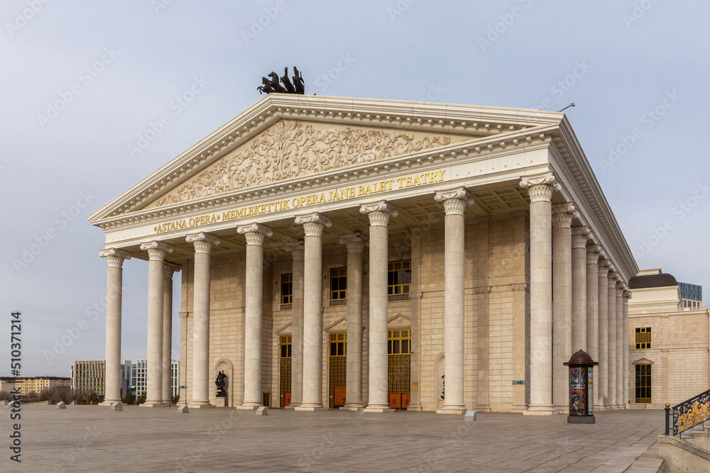 Astana Opera in Nur Sultan (Astana), Kazakhstan, classical style building with golden ornaments, sculptures, columns and pediment.
