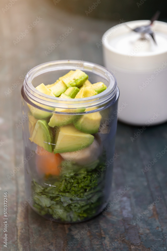 Healthy green smoothie avocado and kale mixed fruits, yogurt and honey in portable blender. Kale is considered a superfood because it's a great source of vitamins and minerals. Healthy green smoothie avocado and kale mixed fruits, yogurt and honey in portable blender. Kale is considered a superfood because it's a great source of vitamins and minerals.