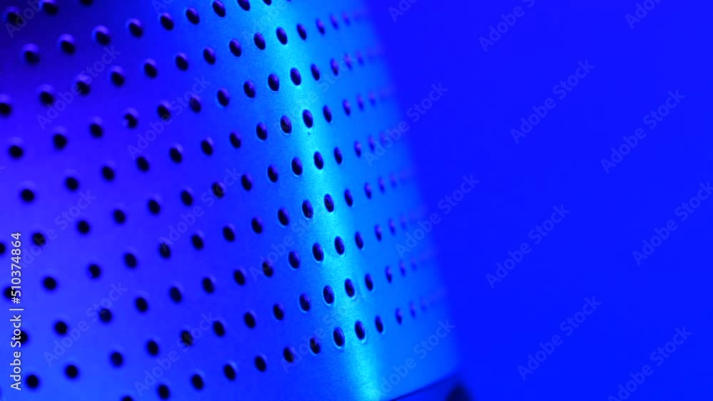 Perforated, cylinder-shaped, object rotated in the rgb led-lights Perforated, cylinder-shaped, object rotated in the rgb led-lights