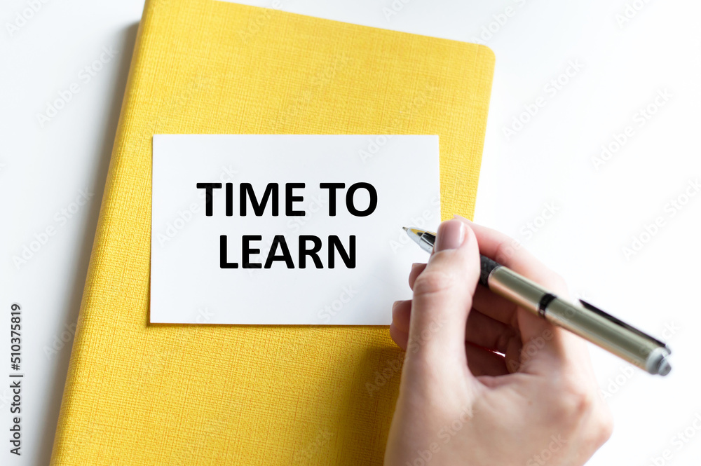 Business concept. Businessman shows a card with the text TIME TO LEARN Business concept. Businessman shows a card with the text TIME TO LEARN