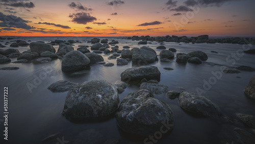 Colorful sunset on the sea rocky shore