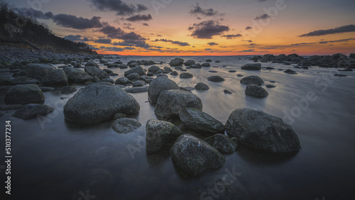 Colorful sunset on the sea rocky shore
