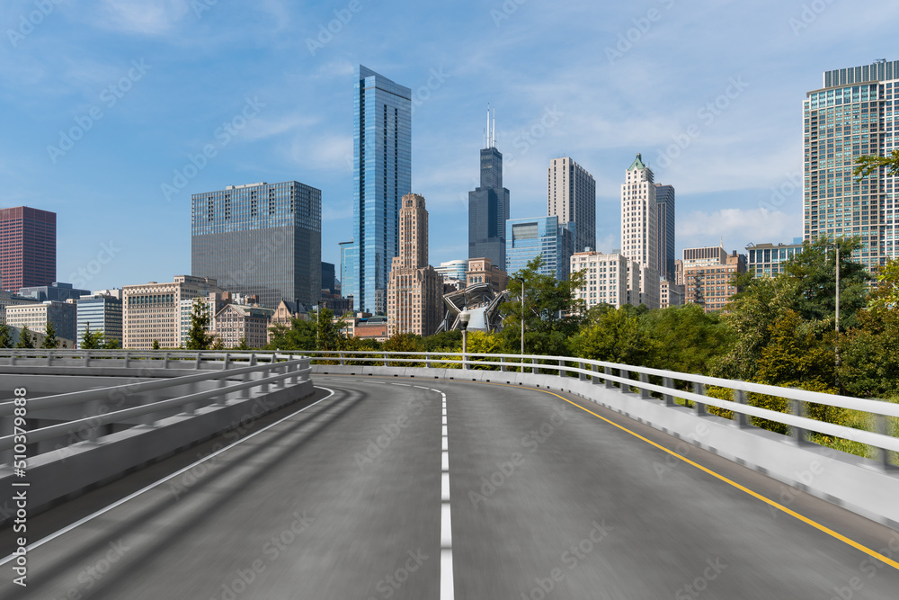 Empty urban asphalt road exterior with city buildings background. New modern highway concrete construction. Concept of way to success. Transportation logistic industry fast delivery. Chicago. USA. Empty urban asphalt road exterior with city buildings background. New modern highway concrete construction. Concept of way to success. Transportation logistic industry fast delivery. Chicago. USA.
