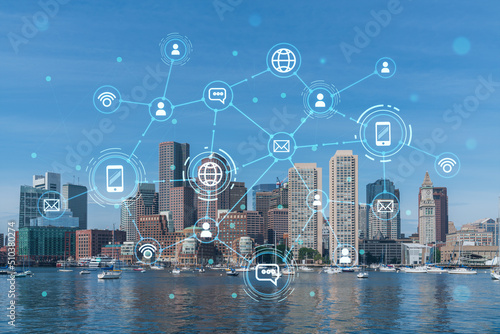 Panorama city view of Boston Harbor at day time, Massachusetts. Buildings of financial downtown. Glowing Social media icons. The concept of networking and establishing new connections between people