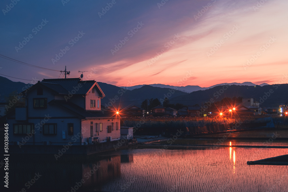 The orange purple sunset in the Japanese village 