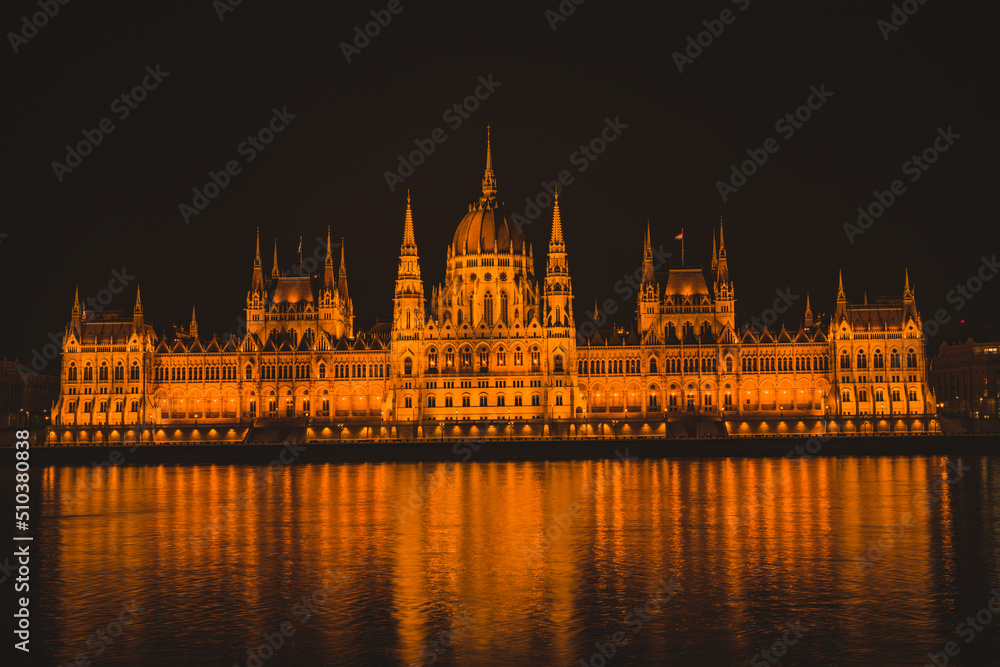 Naklejka premium Hungarian parliament building from across the Danube river at night Budapest Hungary