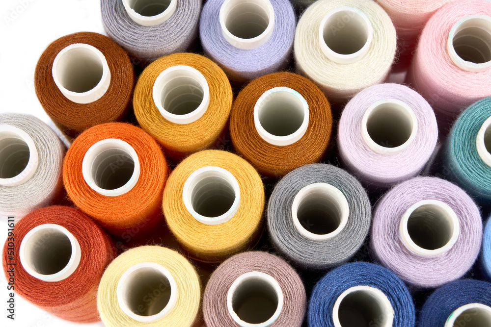 Sewing threads. Spool of thread with on white isolated background. Multicolor sewing threads background. Sewing threads. Spool of thread with on white isolated background. Multicolor sewing threads background.